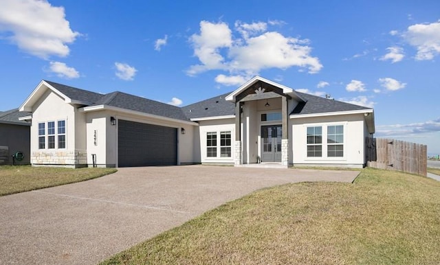 view of front facade with a front yard and a garage