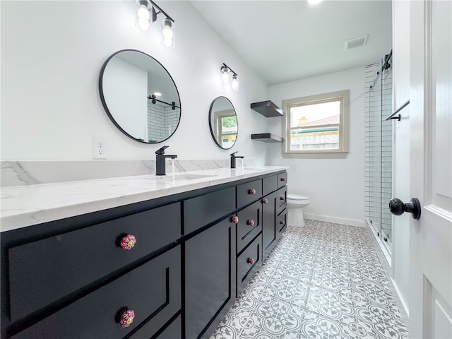 bathroom with toilet, a shower, vanity, and tile patterned flooring