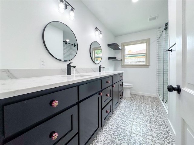 126 Rainbow Ln, Corpus Christi, TX 78411 - bathroom with toilet, a shower with door, double vanity, and baseboards