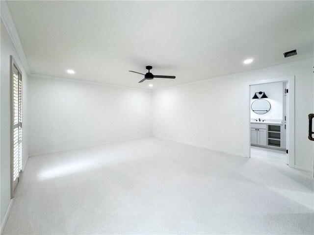 126 Rainbow Ln, Corpus Christi, TX 78411 - unfurnished bedroom featuring crown molding, recessed lighting, light carpet, a sink, and a ceiling fan