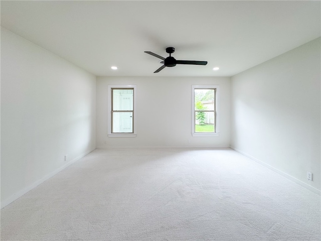 carpeted empty room featuring ceiling fan