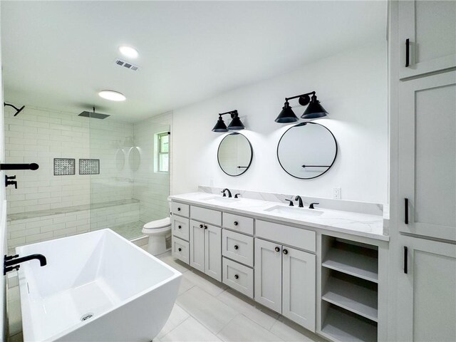 126 Rainbow Ln, Corpus Christi, TX 78411 - full bath with double vanity, a soaking tub, tiled shower, toilet, and tile patterned flooring