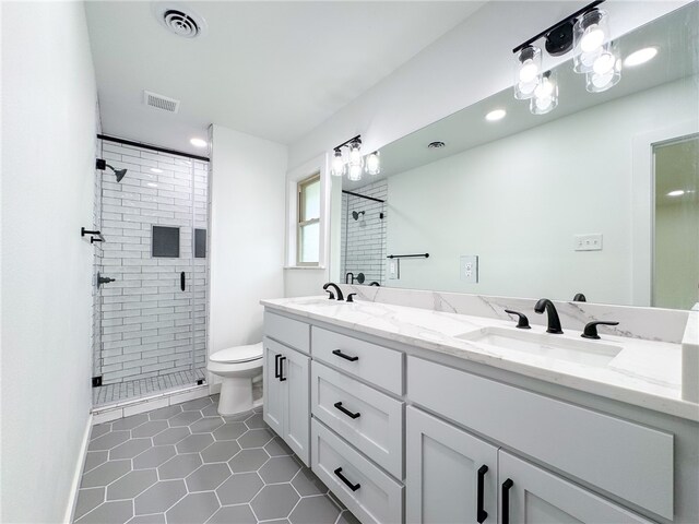 bathroom featuring toilet, tile patterned floors, walk in shower, and vanity