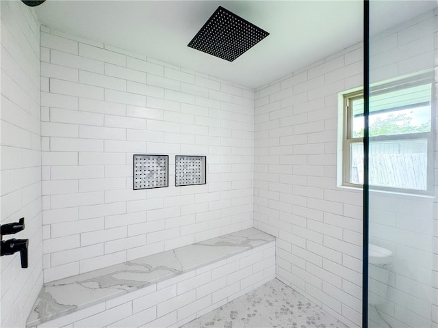 bathroom with a tile shower