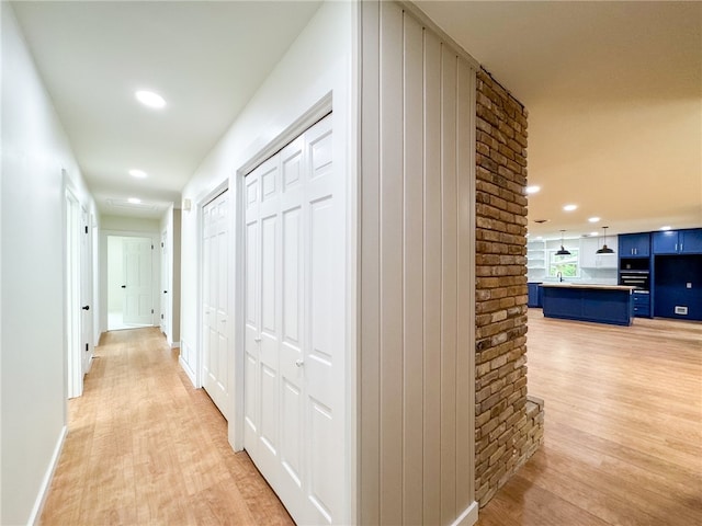 corridor featuring light hardwood / wood-style floors