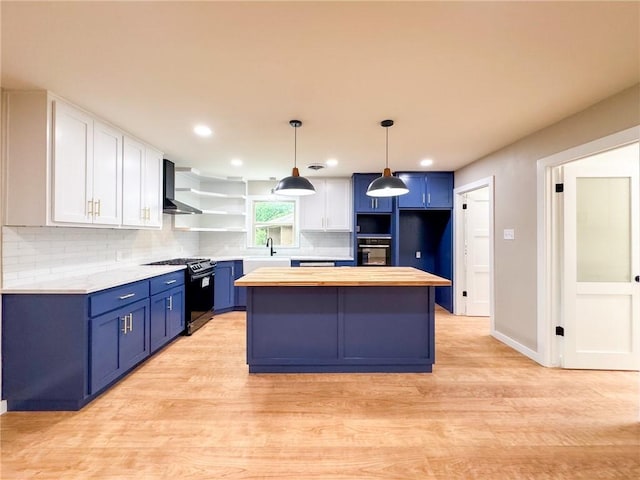 126 Rainbow Ln, Corpus Christi, TX 78411 - kitchen with gas range, butcher block counters, open shelves, blue cabinetry, and black oven