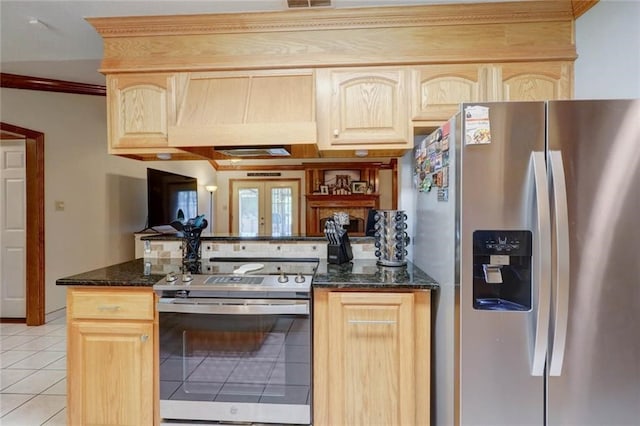 kitchen featuring appliances with stainless steel finishes, light brown cabinets, dark stone countertops, light tile patterned floors, and premium range hood