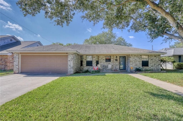 ranch-style house featuring a garage and a front yard