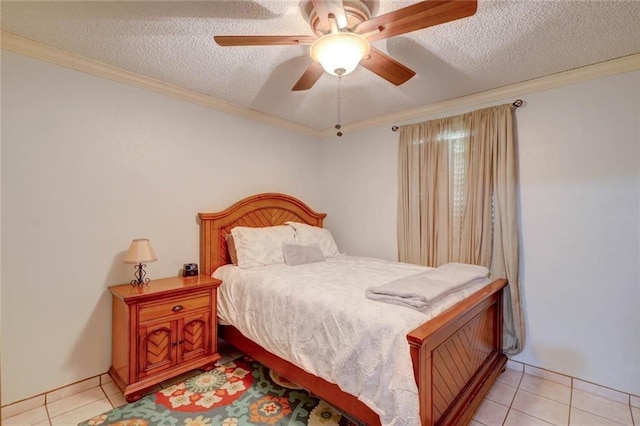 tiled bedroom with ceiling fan, a textured ceiling, and ornamental molding