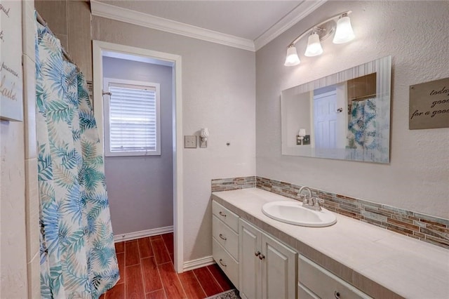 bathroom featuring crown molding, hardwood / wood-style floors, vanity, and tasteful backsplash