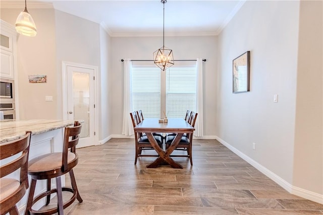 dining space with an inviting chandelier, ornamental molding, and light hardwood / wood-style floors