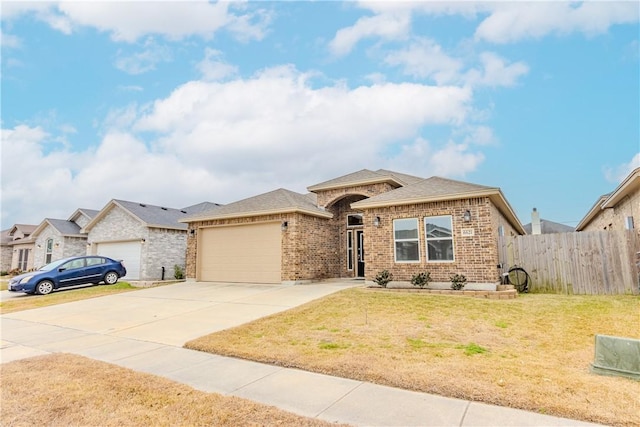 view of front of house with a garage and a front lawn