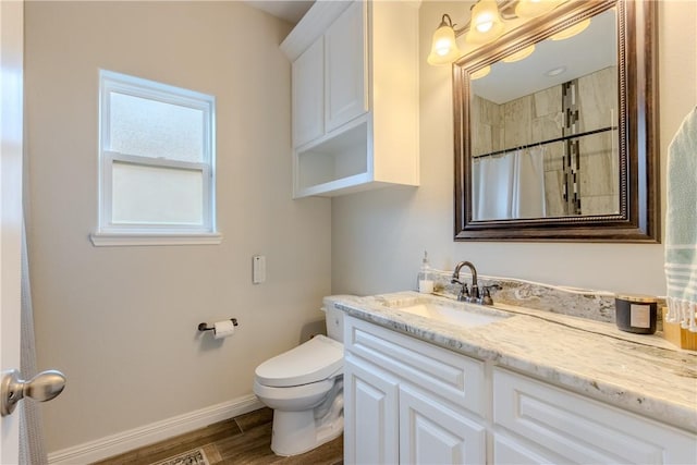 bathroom featuring hardwood / wood-style flooring, vanity, curtained shower, and toilet