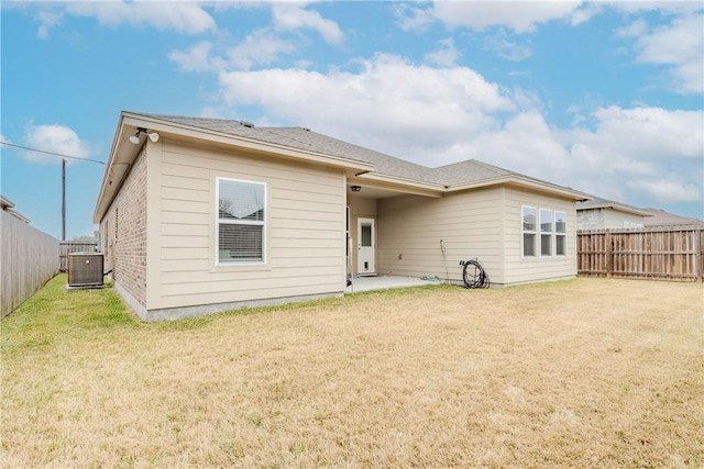 back of property featuring cooling unit, a lawn, and a patio