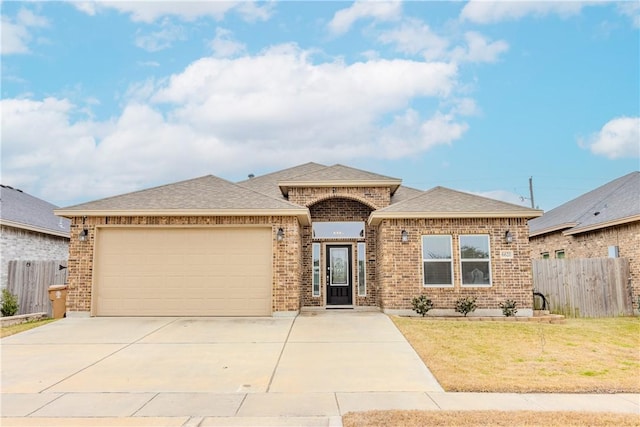 ranch-style house with a garage and a front yard