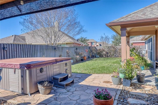 view of patio / terrace with a fenced backyard and a hot tub