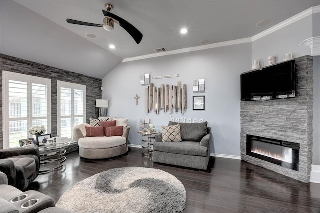 living room featuring lofted ceiling, a fireplace, wood finished floors, baseboards, and crown molding