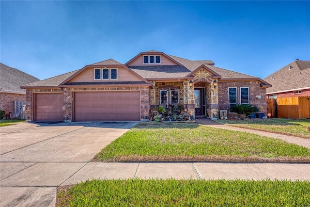 view of front of house with a garage, driveway, fence, a front lawn, and brick siding