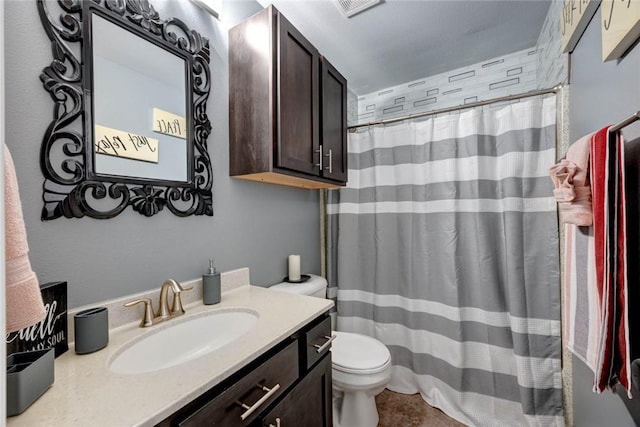 bathroom with curtained shower, vanity, and toilet