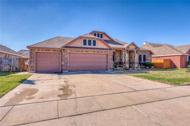 view of front of house featuring an attached garage, fence, concrete driveway, and brick siding