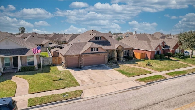 view of front facade with driveway, a front yard, fence, and a residential view