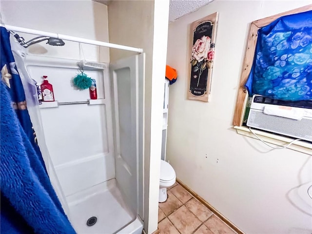 4321 Woodland Creek Dr, Corpus Christi, TX 78410 - bathroom featuring a stall shower, tile patterned floors, toilet, and baseboards