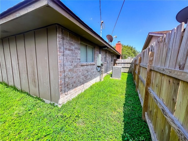 4321 Woodland Creek Dr, Corpus Christi, TX 78410 - view of side of property with brick siding and central AC
