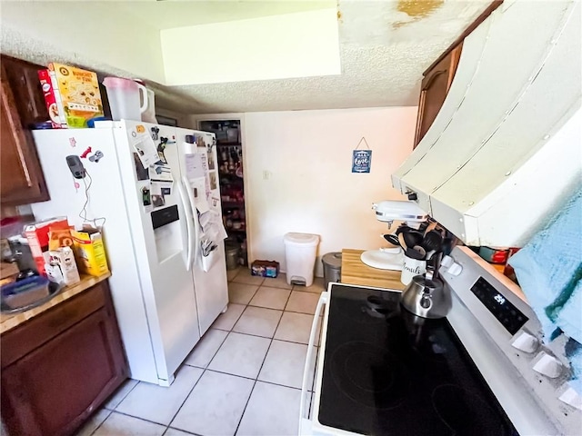 4321 Woodland Creek Dr, Corpus Christi, TX 78410 - kitchen with white appliances, light tile patterned floors, light countertops, and a textured ceiling