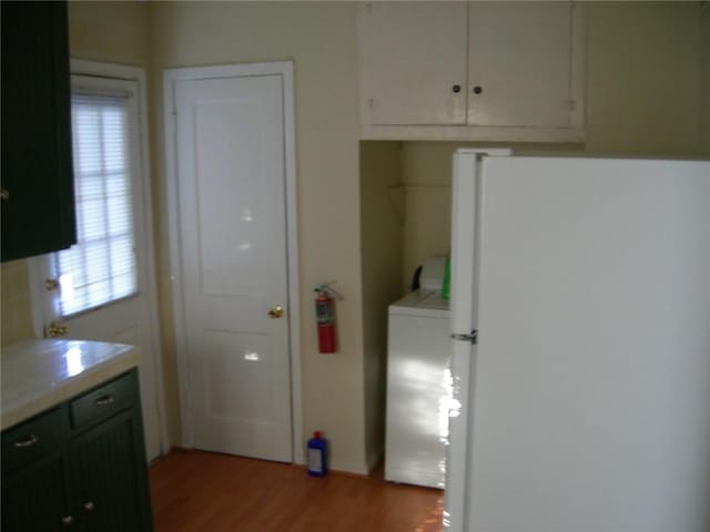 822 Indiana Ave, Corpus Christi, TX 78404 - kitchen featuring washer / clothes dryer, tile counters, light wood-style floors, and freestanding refrigerator