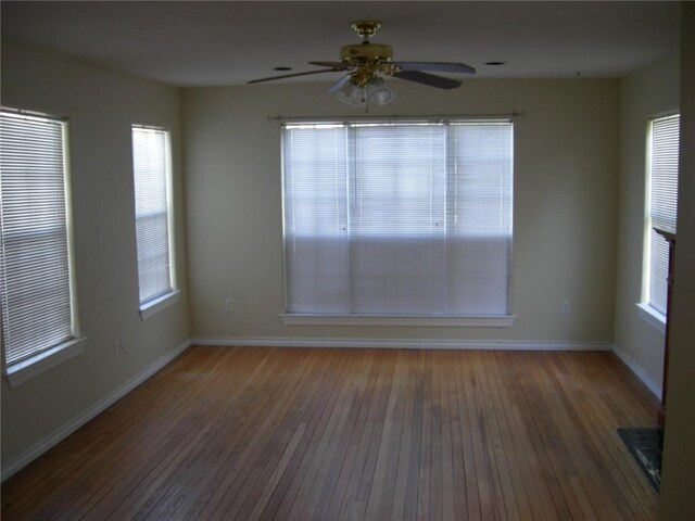 822 Indiana Ave, Corpus Christi, TX 78404 - unfurnished room featuring baseboards, a ceiling fan, wood finished floors, and a healthy amount of sunlight