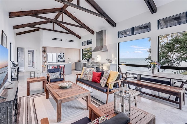 living room with beam ceiling, a water view, and high vaulted ceiling