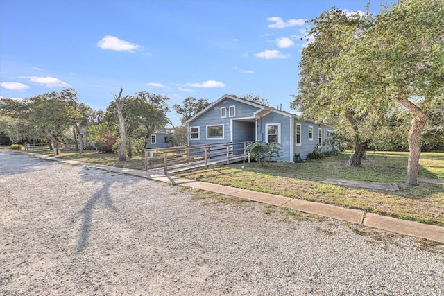 bungalow-style home featuring a front lawn