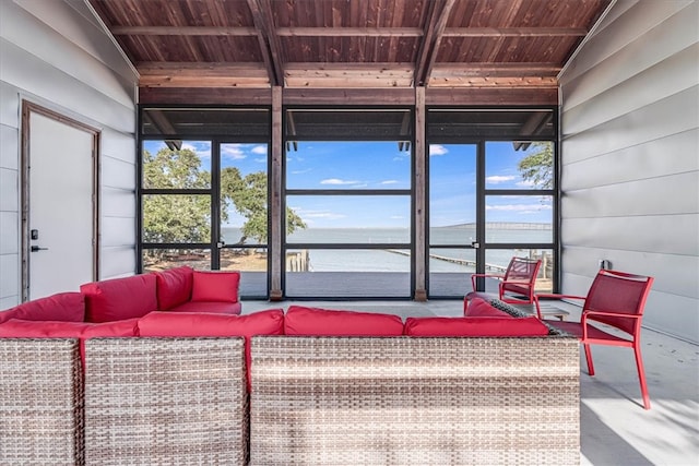 sunroom with a water view, lofted ceiling, and wood ceiling