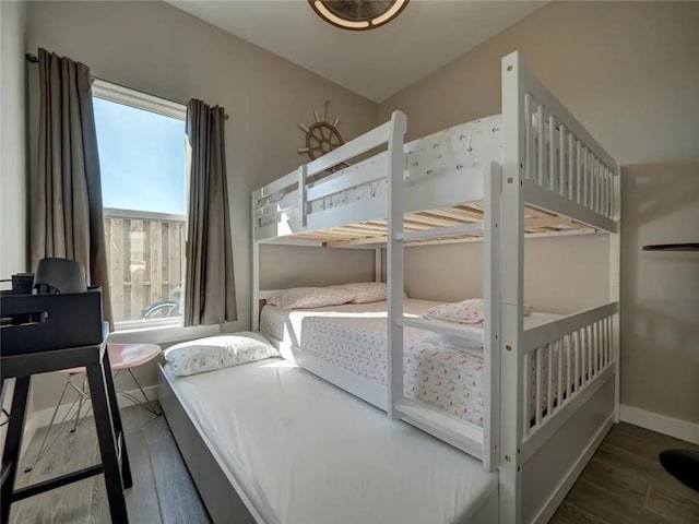 bedroom featuring baseboards and wood finished floors