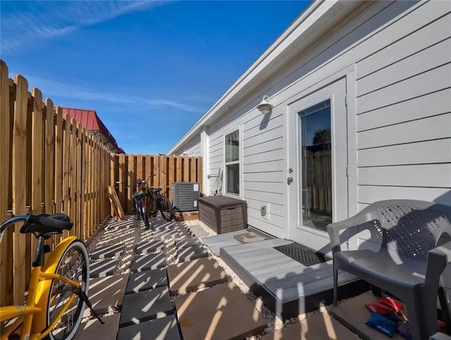 view of patio / terrace with a fenced backyard and central air condition unit