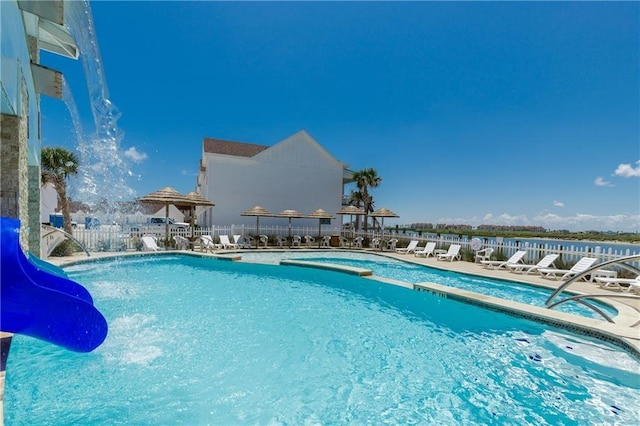 pool featuring fence and a patio