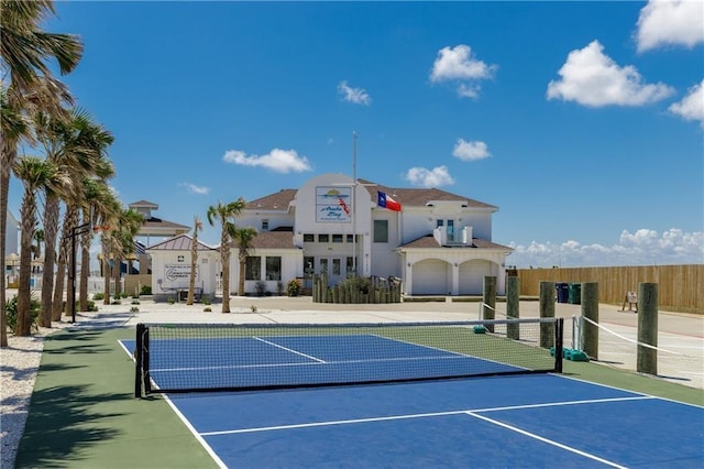 view of sport court featuring fence