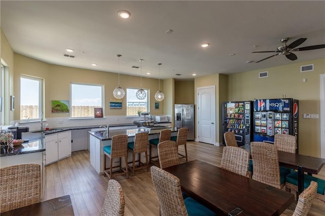 dining room with light wood-style floors, recessed lighting, and visible vents