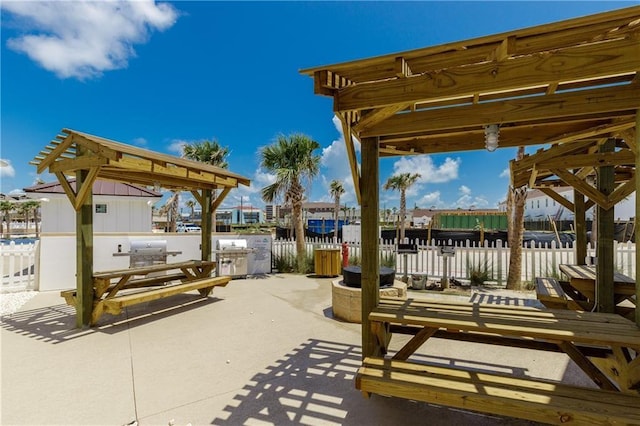 view of patio with fence, area for grilling, and outdoor dining space