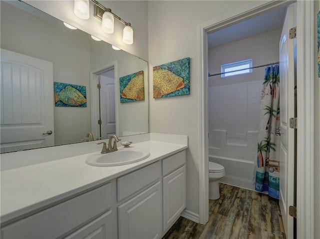 full bathroom with shower / tub combo with curtain, vanity, toilet, and hardwood / wood-style flooring