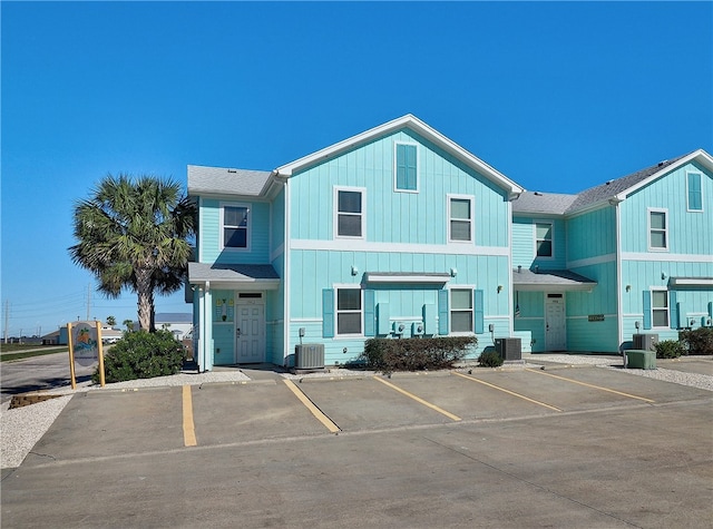 view of front of property featuring central AC unit and a garage