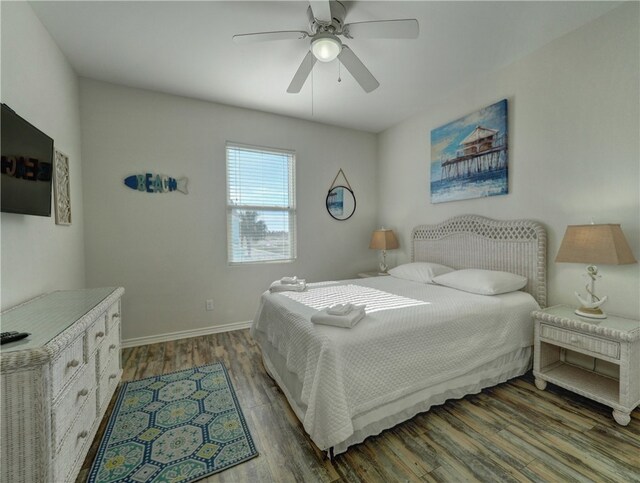 bedroom with dark wood-type flooring and ceiling fan