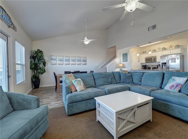 living room featuring high vaulted ceiling, dark wood-type flooring, and ceiling fan