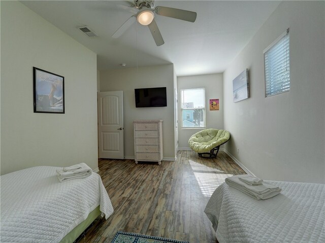 bedroom featuring dark hardwood / wood-style flooring and ceiling fan