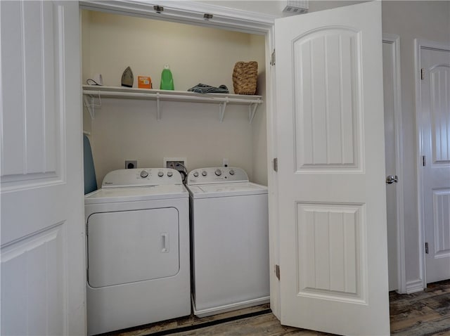 laundry area featuring washer and dryer and dark hardwood / wood-style floors