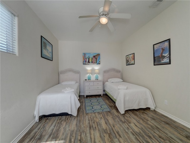 bedroom with dark wood-type flooring and ceiling fan