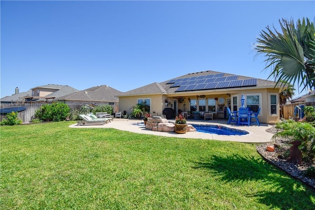back of property with an outdoor hangout area, roof mounted solar panels, a patio, and stucco siding