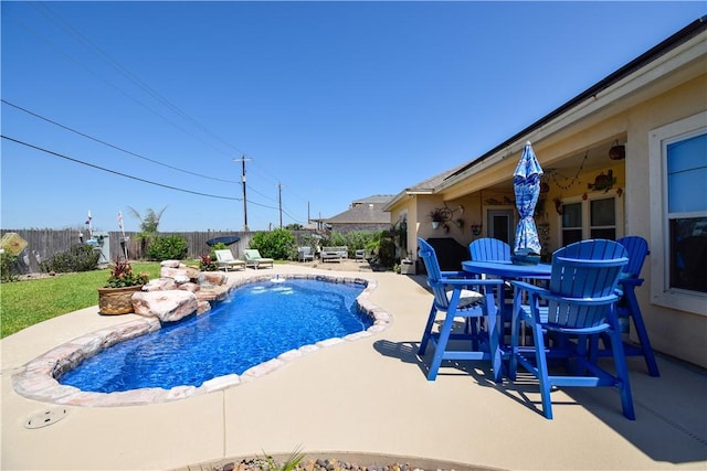 view of pool with a patio area, a fenced backyard, and outdoor dining space