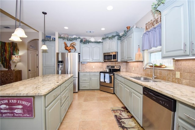 kitchen with stainless steel appliances, a sink, tasteful backsplash, light tile patterned floors, and recessed lighting