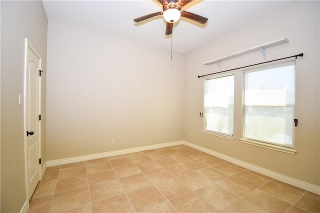 spare room featuring ceiling fan and baseboards